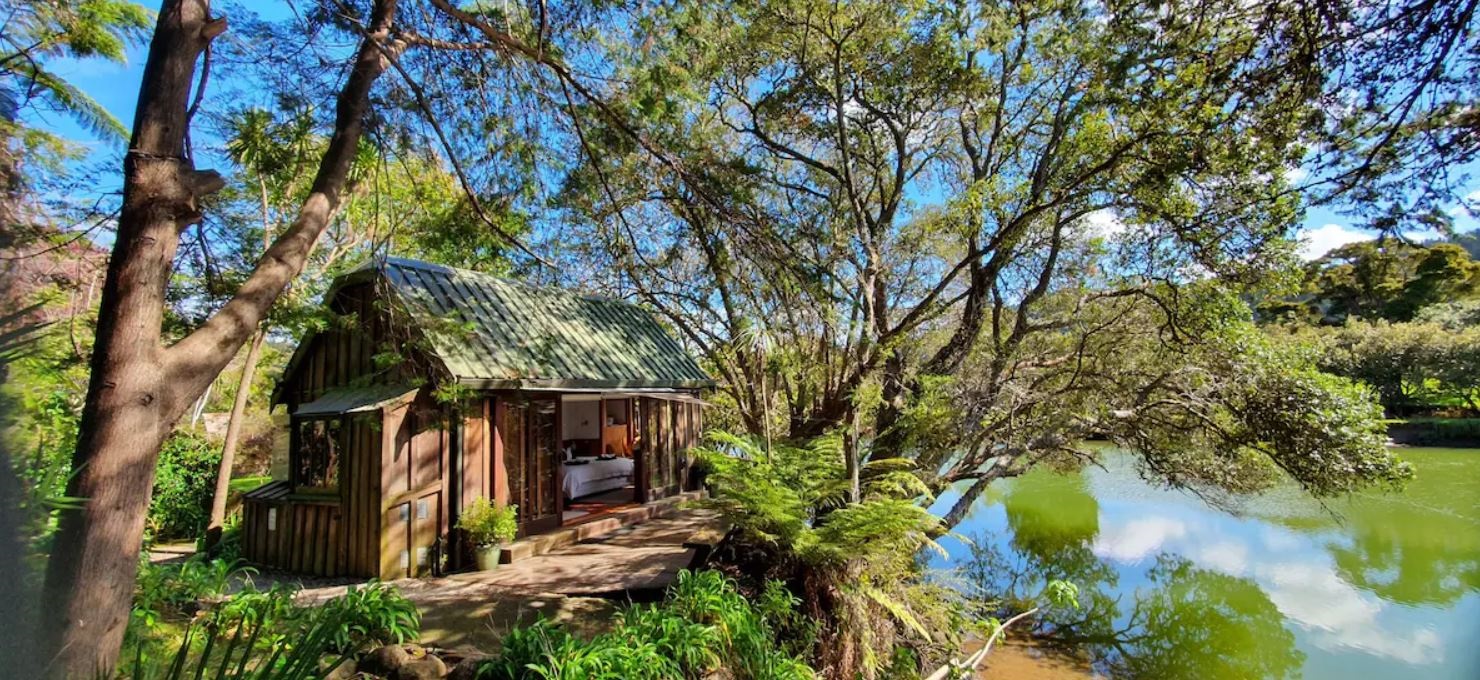A magic Cottage set in woods in New Zealand, available as a holiday rental.